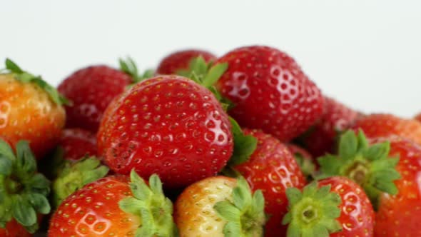 Juicy ripe exotic strawberry rotates on a white background 360. Eco fruits and berries summer.