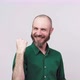 Successful man celebrating a victory and raising clenched fist in the air over white background. - VideoHive Item for Sale