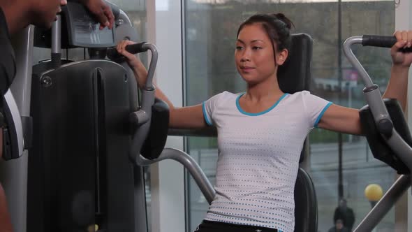 Female and male coach, working out in gym