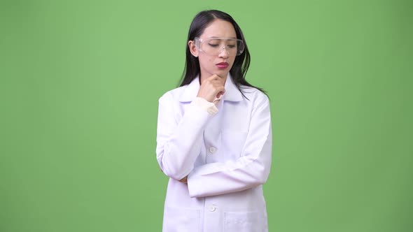 Young Beautiful Asian Woman Doctor Wearing Protective Glasses