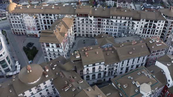 Aerial View Flying Over Roofs Touristic Hotel Area Surrounded By Mountains Valley Landscape at