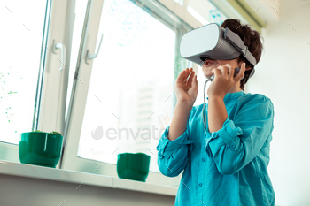 Pupil of smart school wearing VR glasses