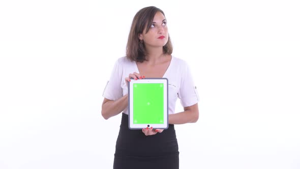 Happy Beautiful Businesswoman Thinking While Showing Digital Tablet