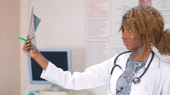 Female African-american Doctor Examines X-ray of Lungs in Clinic. Concept of Medicine, Health Care