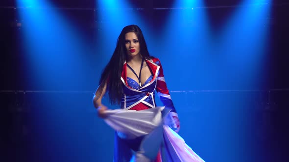 Passionate Girl Dancing in a Sexy Suit in the Color of the English Flag and Rhinestones. Attractive