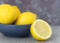 A blue bowl of lemons fruit on a table a - PhotoDune Item for Sale