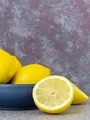 A blue bowl of lemons fruit on a table - PhotoDune Item for Sale