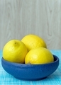 A blue bowl of lemons on a table - PhotoDune Item for Sale