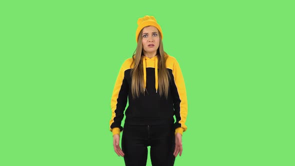 Modern Girl in Yellow Hat Is Upset, Waving Her Hands in Indignation. Green Screen