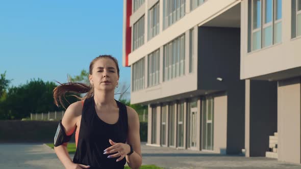 Girl in Black Tracksuit Start Runs Past Modern Building on Street