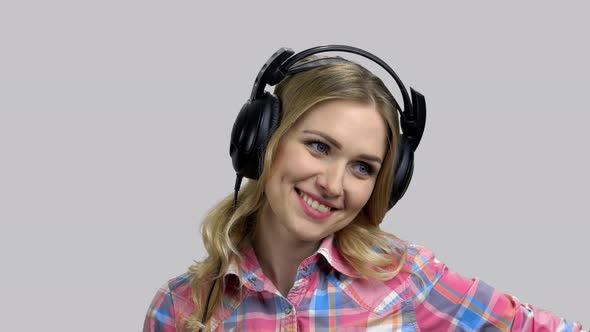 Young Positive Woman Wearing Headphones and Talking