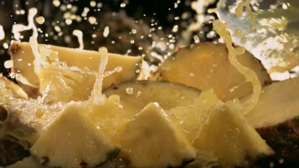Slow Motion Shot of Pineapple and Juice Splashing Through Pineapple Slices