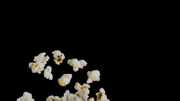 Popping Popcorn Flying and Falling Isolated on Black Background