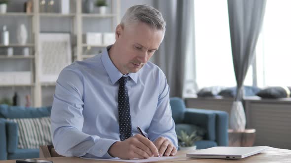 Gray Hair Businessman Writing a Letter