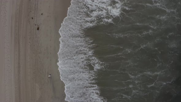 AERIAL: Birdsview on Waves,water on Beach in Venice, Los Angeles, California 