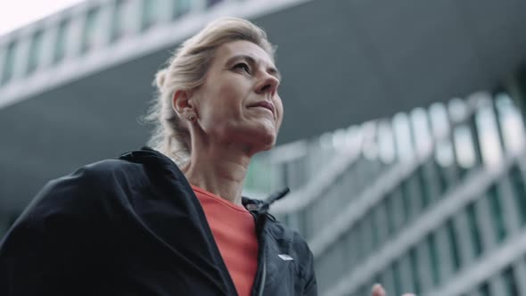 Fitness Mature Woman in Activewear Running on City Street