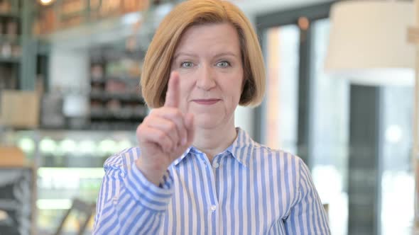 Portrait of Creative Old Woman Pointing at Camera and Inviting 