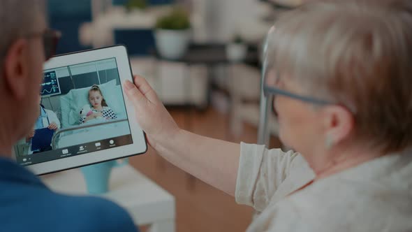 Grandparents Using Remote Videoconference on Digital Tablet