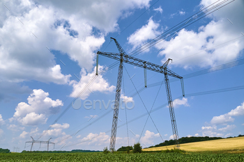 gh voltage electricity located in agricultural cornfield. Delivery of electrical energy concept.