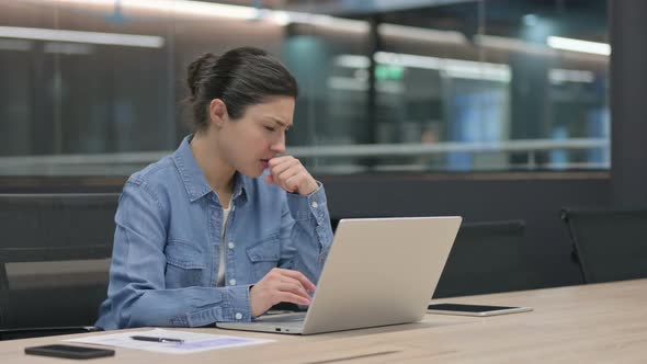 Indian Woman Coughing While Using Laptop at Work