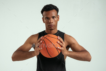 Best game. Handsome young african man holding basketball ball and looking at camera while standing