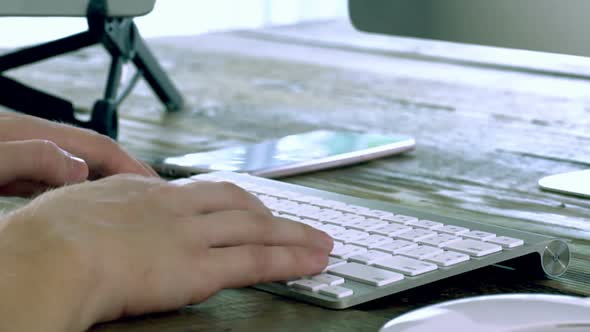 A Caucasian Male Typing on a Wireless Keyboard 06