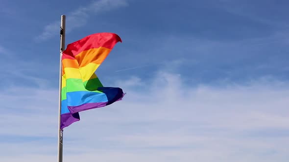 The Rainbow Flag, with its six colours fluttering in the breeze on a Sunny day in Brighton