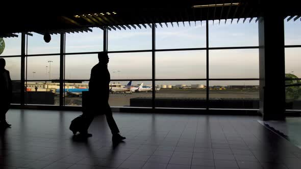 Men and Women with Bags Walking at Airport Terminal, Traveling and Vacation