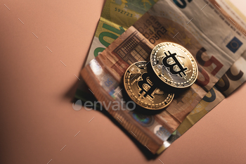 Golden coin with bitcoin symbol and euro banknote