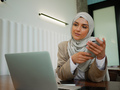 Muslim woman on remote working, online education or video conversation in caffe - PhotoDune Item for Sale