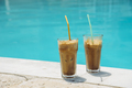 Two glass of iced frappe near the swimming pool. - PhotoDune Item for Sale