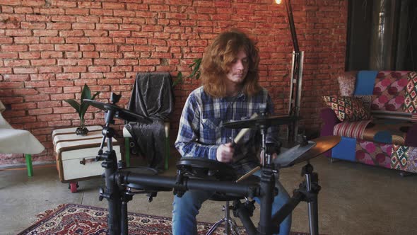 Young Redhead Man Drummer Playing Electric Drums at Home Slow Motion