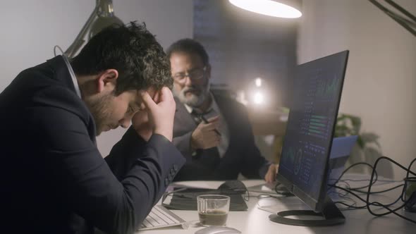 Two Businessmen Working Together in Office Late