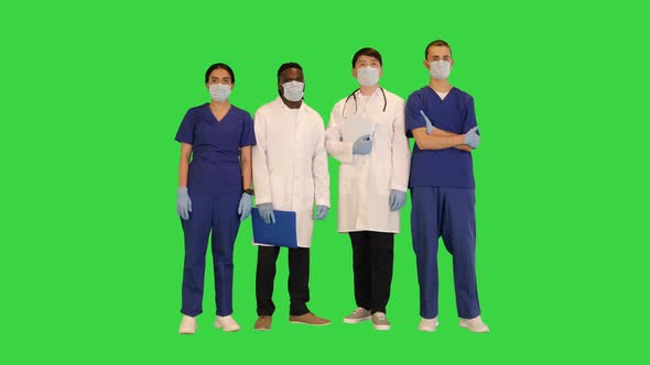 Multiracial Group of Young Doctors Stand Straight in Front of Camera on a Green Screen Chroma Key