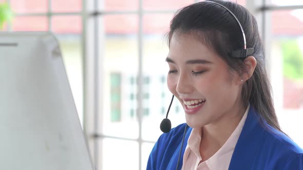 Businesswoman Wearing Headset Working Actively in Office