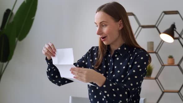 A Woman Receives a Notification Reads the Good News in a Letter