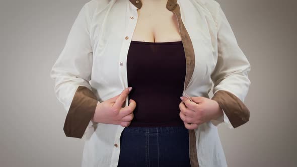 Unrecognizable Caucasian Fat Woman Fastening Shirt. Obese Adult Girl Having Overweight Problems