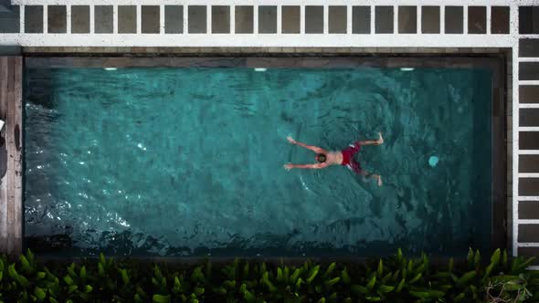 Young Man in Red Swimming Trunks Jump in the Pool