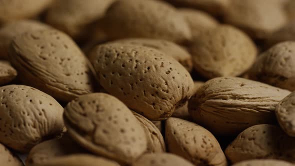 Cinematic, rotating shot of almonds on a white surface - ALMONDS