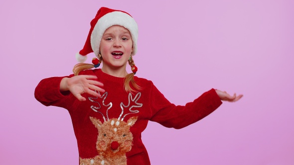 Girl in Christmas Santa Sweater Hat Dancing Trendy Dance for Social Media Fooling Around Having Fun