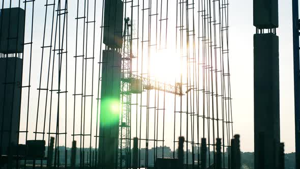 Building Crane and Metal Carcasses in Sunlight