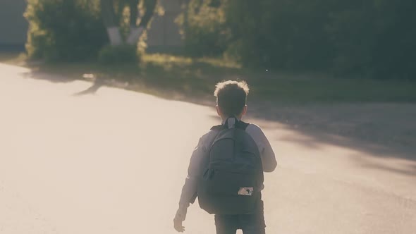 Running Boy Jumps Up on Road and Throws Papers After Exam