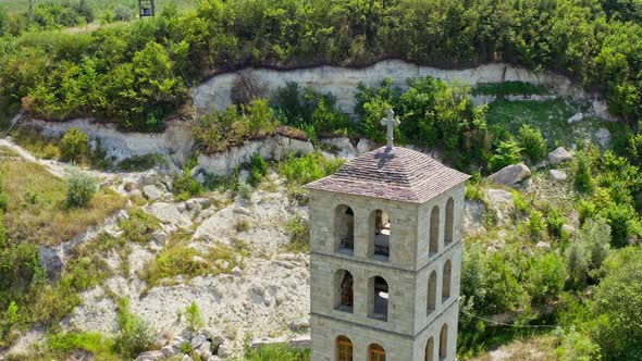 Stone building surrounded with nature. Unfinished church in the mountains.