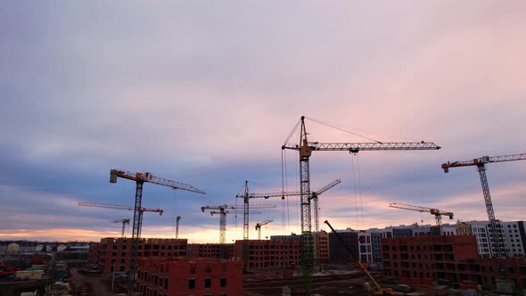 Construction Cranes At Sunset