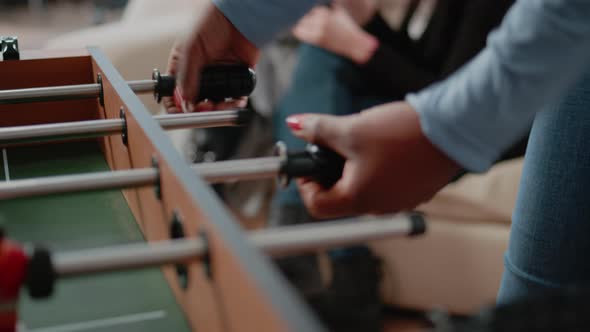 Close Up of Woman Using Foosball Game Table to Do Fun Activity