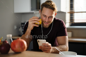 es, browsing on mobile phone while sitting in the kitchen, eating apple