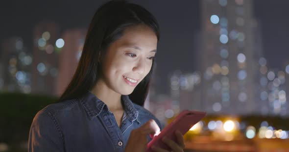 Woman use of smart phone at night