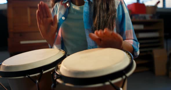 Schoolgirl playing drum in music class 4k