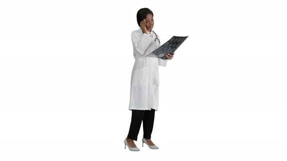 Female Medical Doctor Reading x Rays of Patients Brain on White Background.