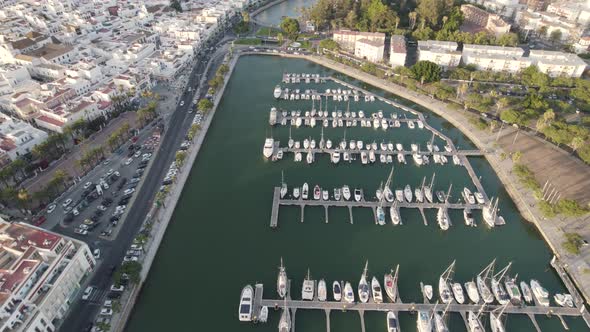 Boats dock at Port Ayamonte, Spain, Estero de la Rivera, drone flyover